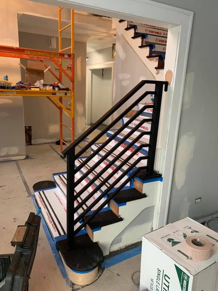 Interior stair railing with a wood handrail