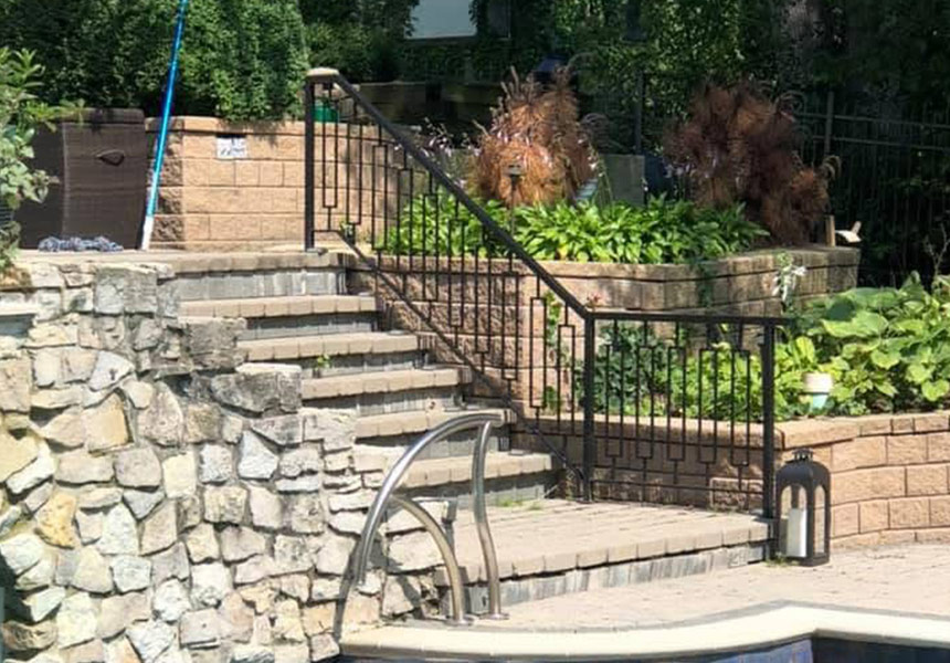 Black metal railings along outdoor stone stairs
